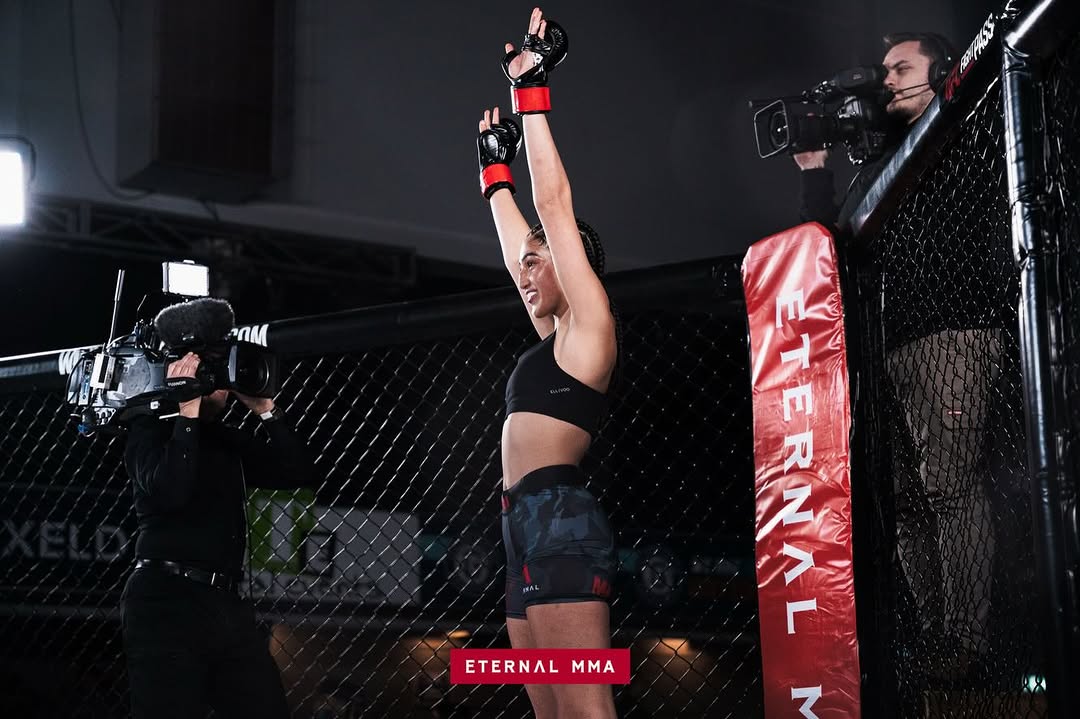 Ana Arvan with both arms raised after winning her amateur debut at Eternal MMA 107